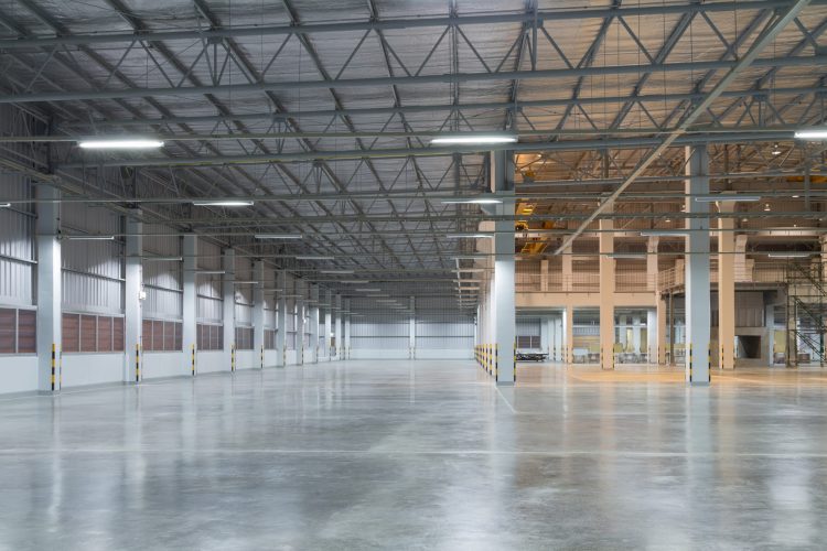 Empty factory building or warehouse building with concrete floor for industry background. Empty factory building or warehouse building with concrete floor for industry background.